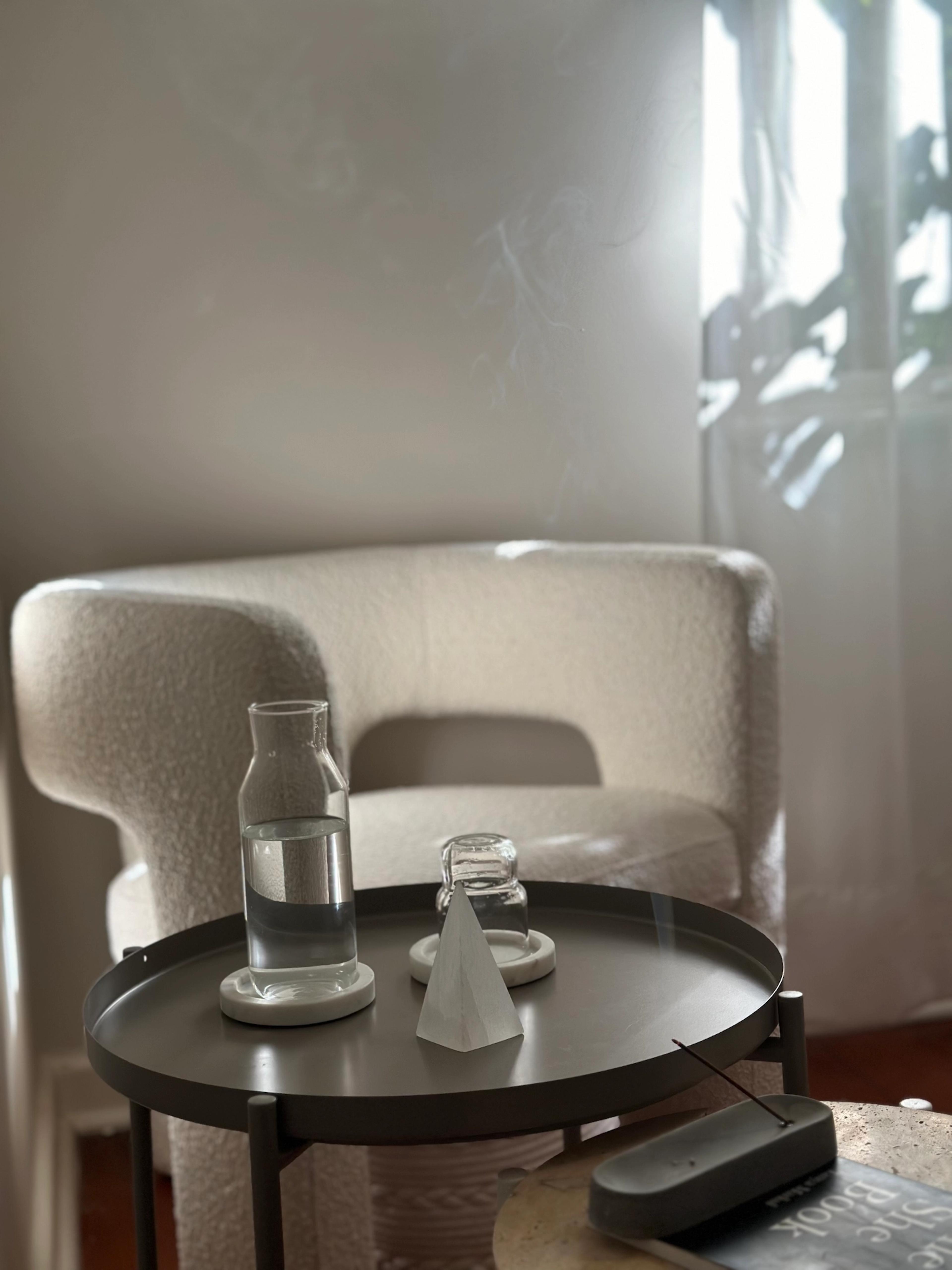 Image of a table from the Studio with water and an inciense